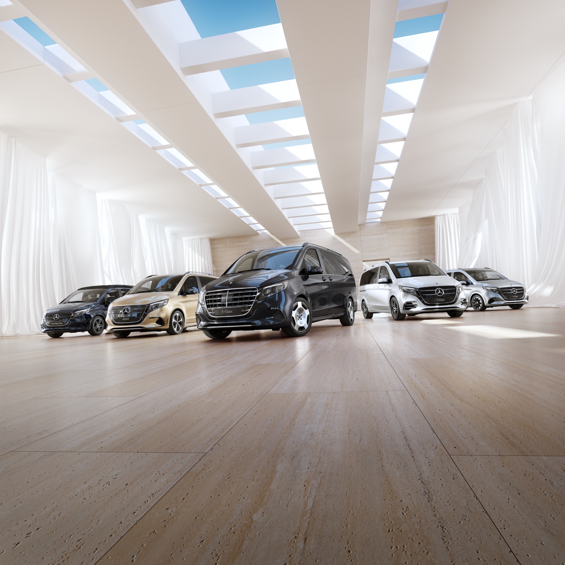 Komfort | EQV | Dodávková vozidla Mercedes-Benz Modely dodávkových vozidel a kempinkových automobilů Mercedes-Benz stojí v showroomu.
