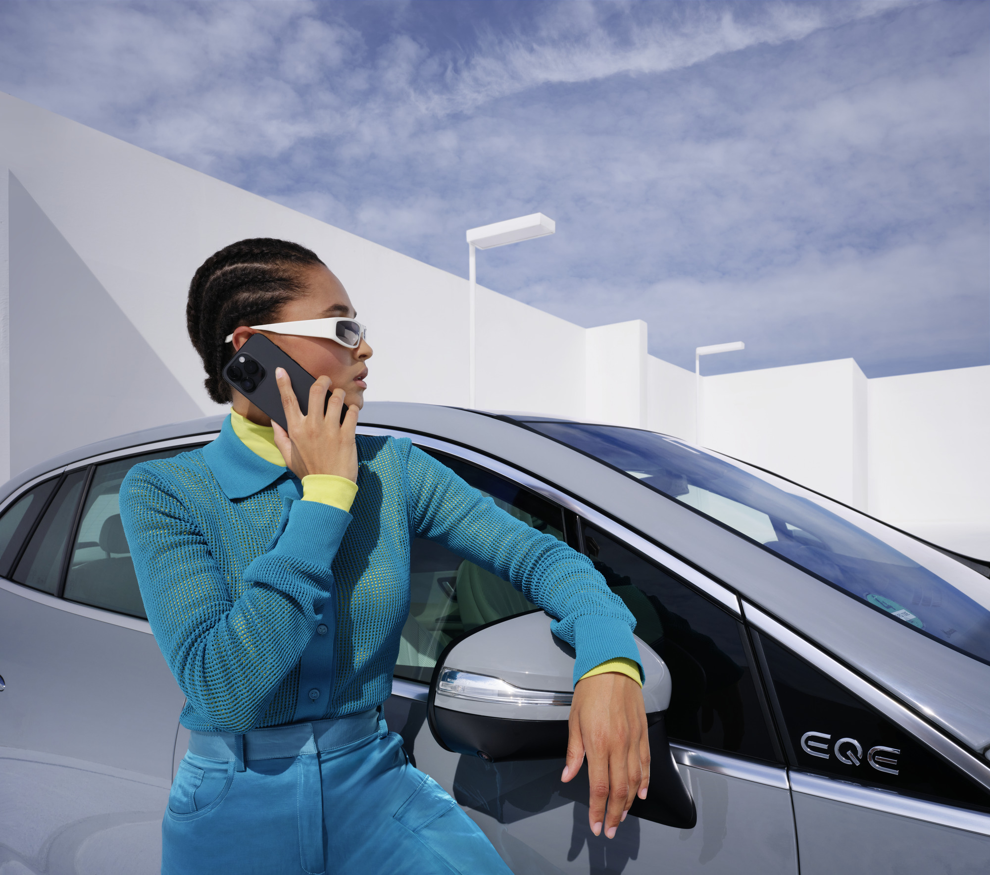 Řešení nehod a poruch | Mercedes-Benz Osoba se opírá se o vozidlo Mercedes-Benz s telefonem v ruce.