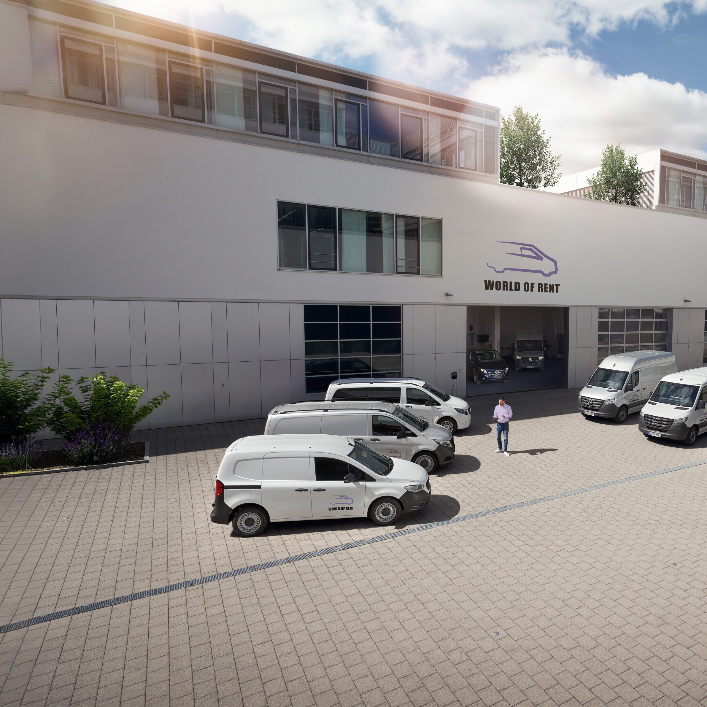 A fleet of Mercedes-Benz vehicles in front of a company building.